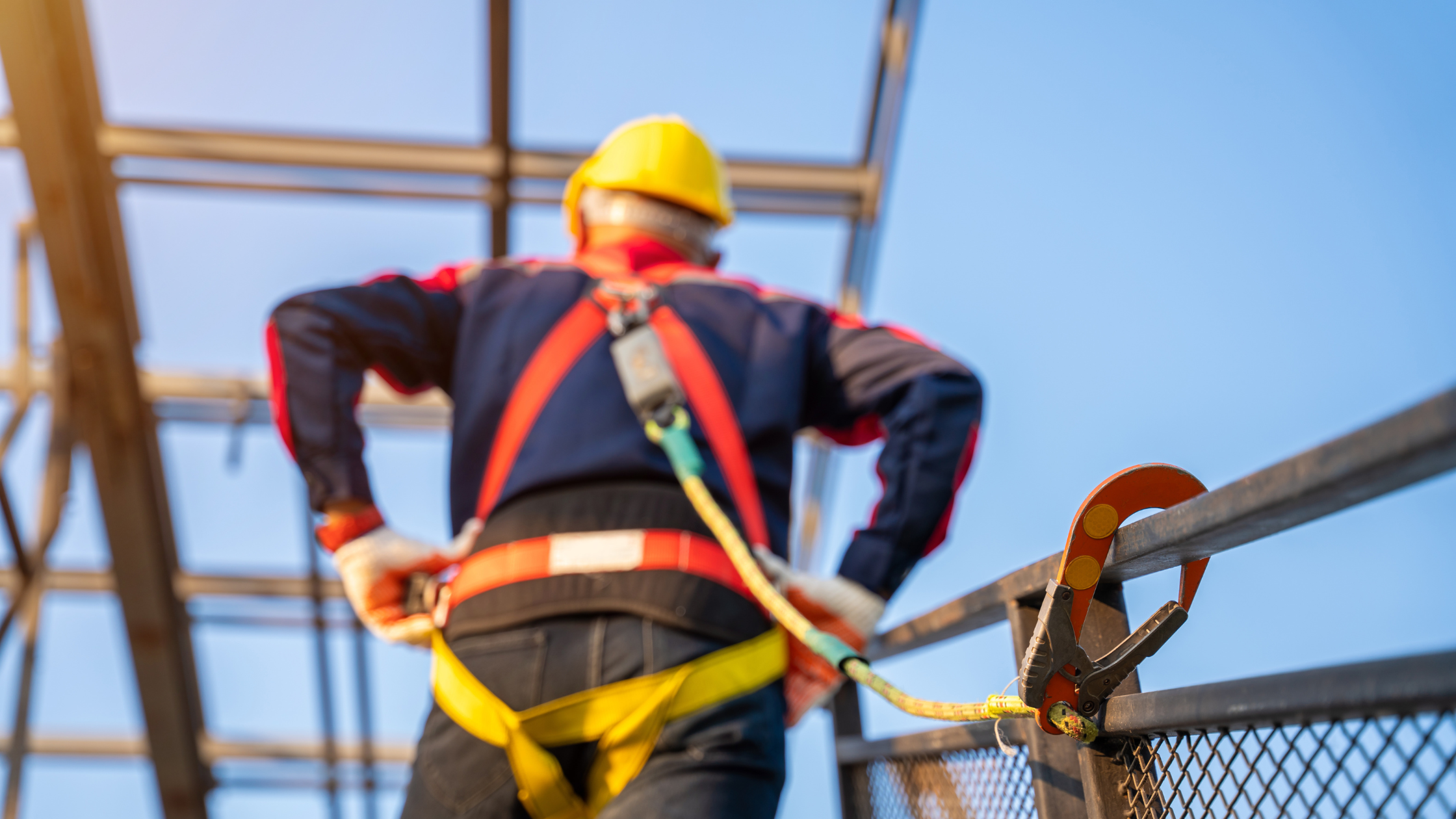 Construction worker following OSHA safety standards using fall protection